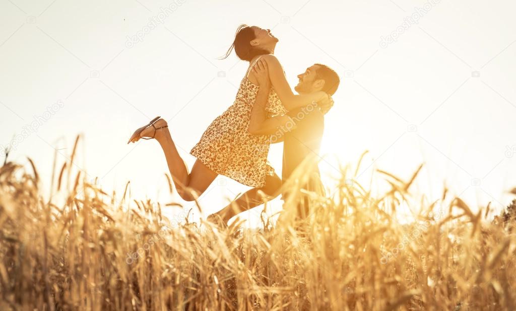 couple in love having fun in a wheat field