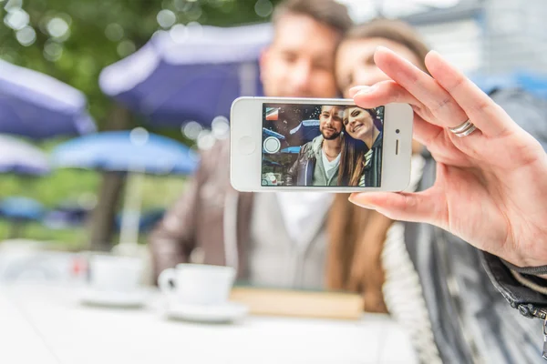 Couple taking a selfie in a bar — Stock Photo, Image