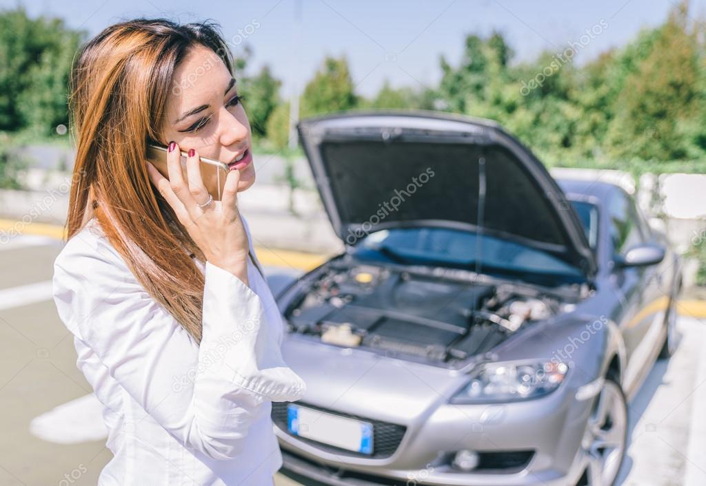 Car breakdown. young woman calling assistance