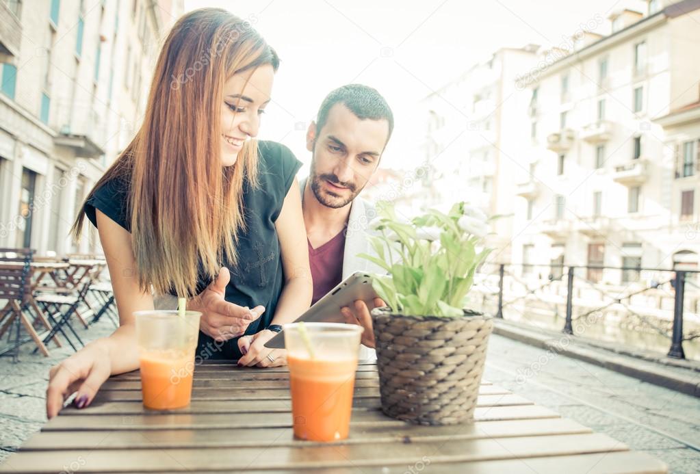 Young couple drinking a vegan shake in a bar.