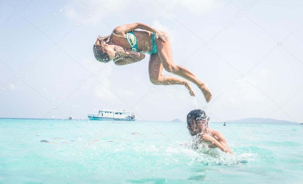 Couple having fun into beautiful clear water