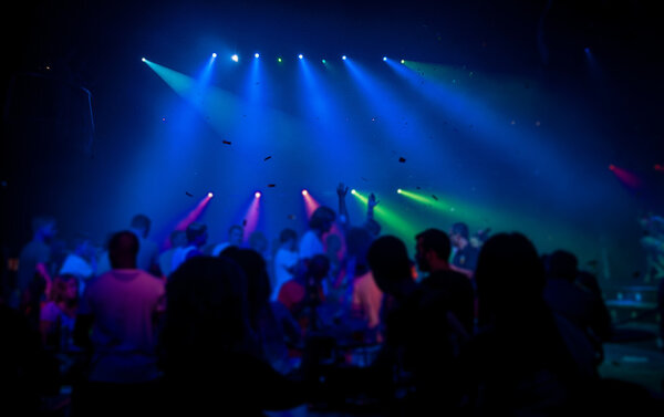 People silhouettes dancing in a club