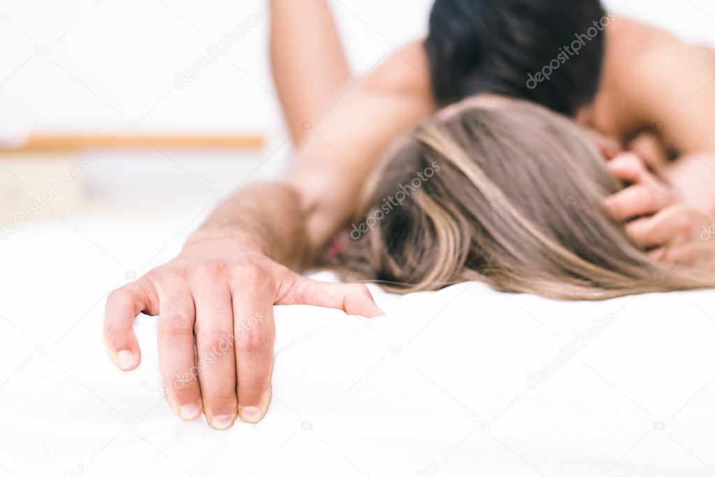 Young couple having romantic fun in bed 