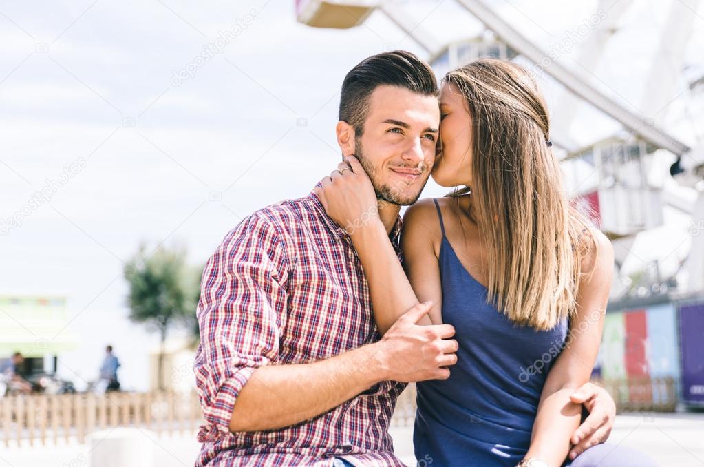Happy couple at the amusement park 