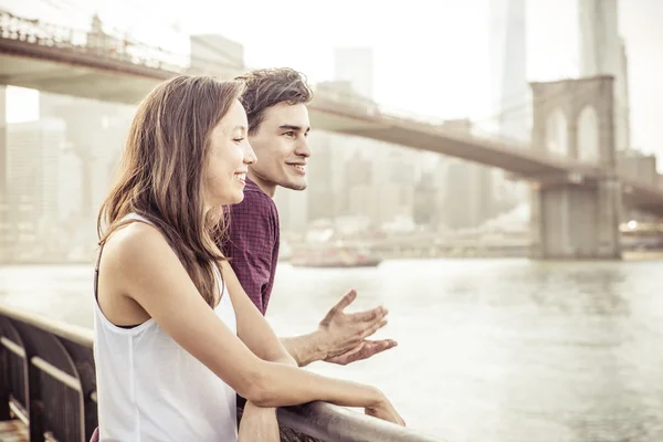 Casal feliz conversando na frente da famosa ponte Brooklyn — Fotografia de Stock