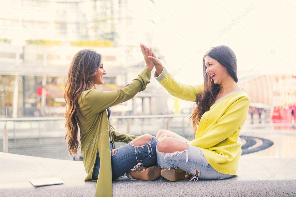 Two women giving high five