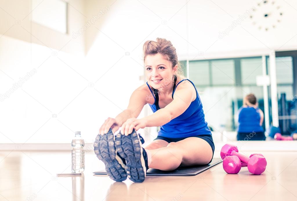 Woman stretching in a gym