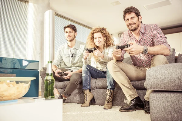 Vrienden spelen van videogames in de woonkamer — Stockfoto