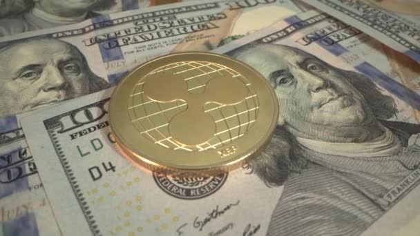 Popular crypto coin Ripple XRP lies on USD bank notes. 100 american dollars against fold digital cryptocurrency. Blockchain concept — Stock Video