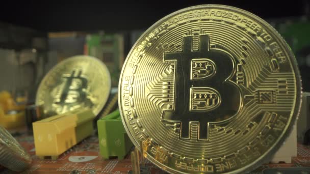 2 popular crypto coins Bitcoin stay on the motherboard in macro shot. Growing price of popular cryptocurrency concept. Focus shifts from one coin to another. — Stock Video