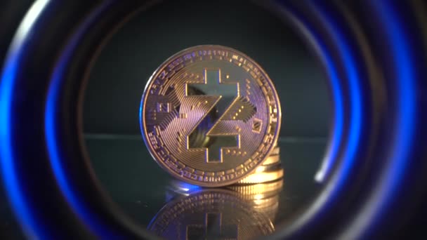 Gold coin Zcash ZEC in the center of tunnel with beautiful blue and yellow light. Camera move back in defocus of polular digital cryptocoin. Blockchain technology. Time is running out. The coin keeps — Stock Video