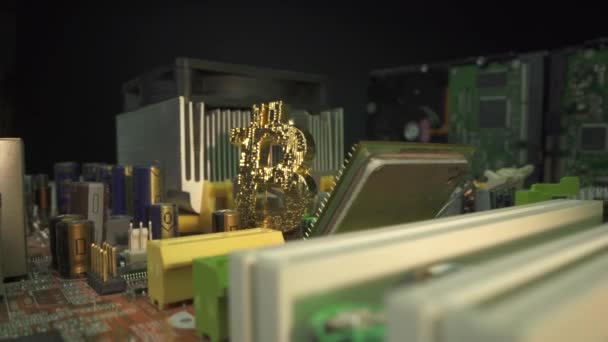 Bitcoin BTC and CPU processor on the motherboard with rotating. Main digital cryptocurrency. Modern technology. Gold coin in detain macro shot. Trading on the market concept. — Stock Video