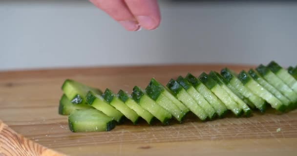 Wanita itu menabur mentimun segar untuk salad. garam untuk rasanya. salad segar .jar dengan mentimun, acar gherkins memasak. Rekaman 4k berkualitas tinggi. garam — Stok Video