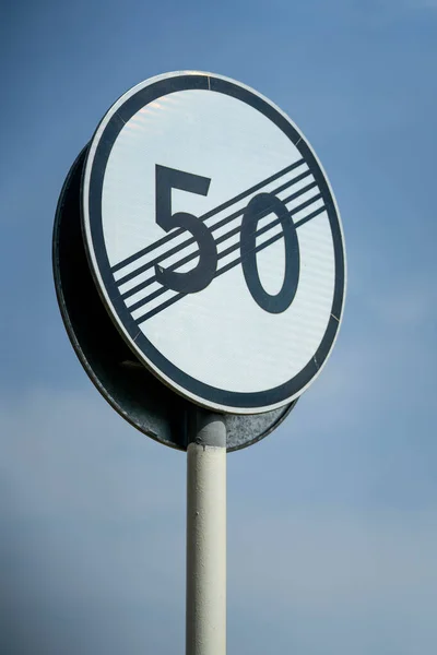 Speed limit zone ends sign on white background with clipping. Traffic signs. Spanish traffic signal: end of speed limited to 50 km per hour. Close up shot