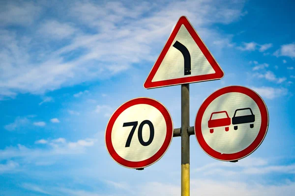 road sign overtaking is prohibited. road sign speed limit 70 km h. road sign turn right