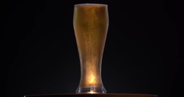 Rotation of Cold Light Beer in a glass with water drops. Craft Beer close up. — Stock Video