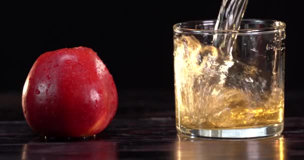 Pouring apple juice into the glass in summer — Stock Video