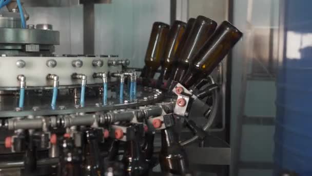 Proceso de embotellado de bebidas en la producción de bebidas gaseosas, limonada, cerveza en botellas de vidrio en la línea transportadora automática. Fabricación de bebidas carbonatadas. — Vídeos de Stock