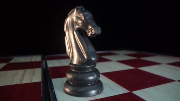 Plastic horse chess game piece alone isolated on black background — Vídeos de Stock