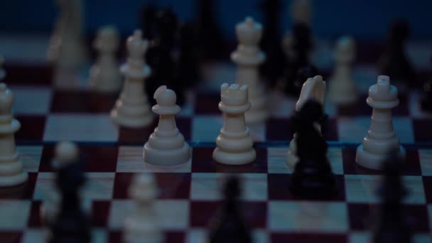 Chess pieces on a chessboard in a colorful fashion style. Flash strobe effect. TV light concept, deadline, fashion, strategy, startup, business. Depth of field, soft focus. Red camera, 4K — Stock Video