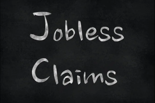 Chalk writing on a slate board Jobless Claims. Financial Market Concept