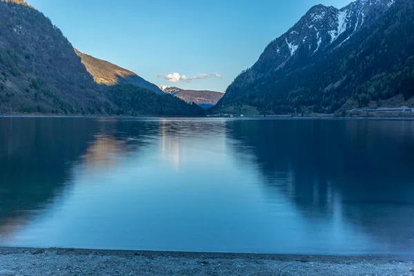 五彩缤纷的落日映照在瑞士波西阿沃湖中的群山 — 图库照片
