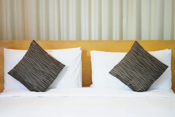 Pillows on white bed — Stock Photo, Image