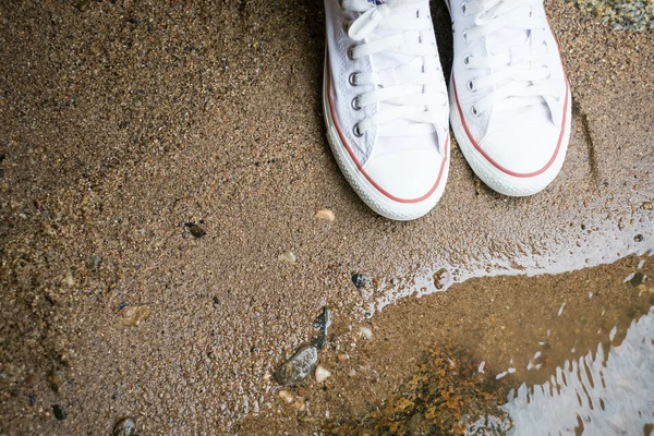 White sneaker on beach sand — Stock Photo, Image