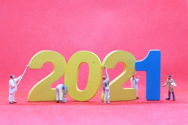 Miniature worker team painting number 2021  , Happy new year concept