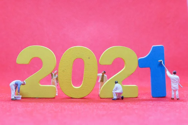 Miniature worker team painting number 2021  , Happy new year concept