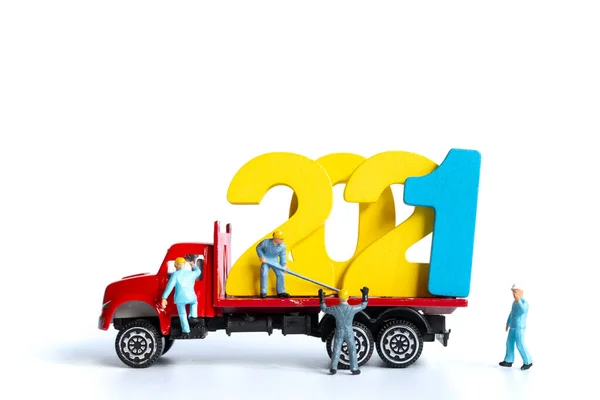 Miniature people : Worker team build wooden number 2021  , Happy new year concept