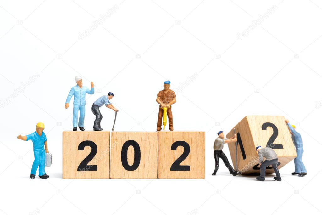 Miniature people : Worker team create wooden block number 2022 , Happy new year concept