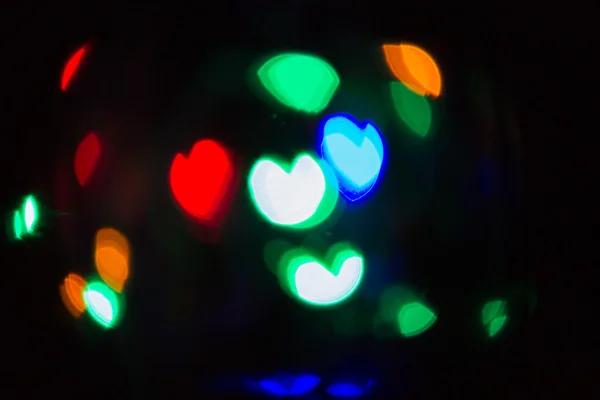 Bella a forma di cuore Bokeh su sfondo nero — Foto Stock