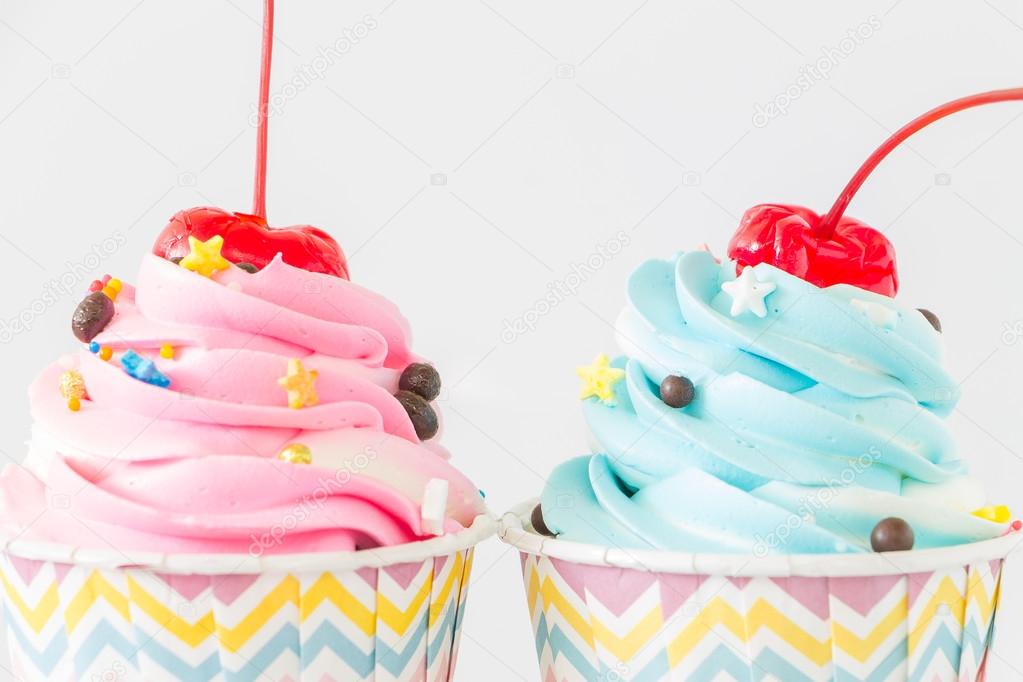 Colorful Cupcakes with icing and chocolate on white background