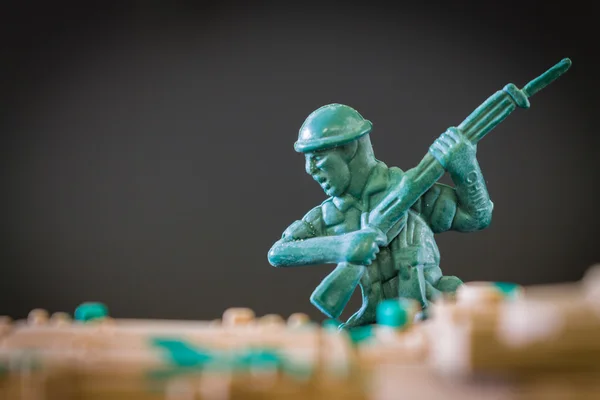 Closeup of action mini toy soldier on black background — Stock Photo, Image