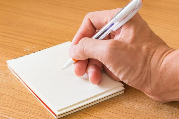 stock image Hand with pen writing on empty paper