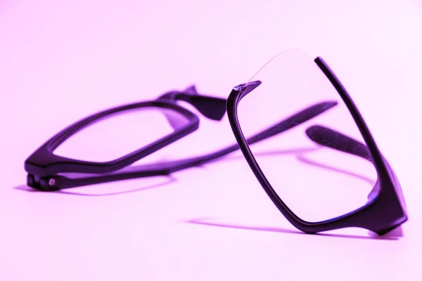 Closeup of Broken plastic Eyeglasses on colored background — Stock Photo, Image