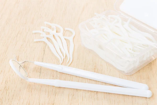 Oral Device : A box of white dental floss on wooden background — Stock Photo, Image