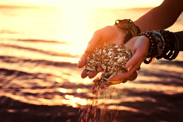 Ung kvinna händer som håller sanden på stranden. naturliga sommaren bakgrund — Stockfoto