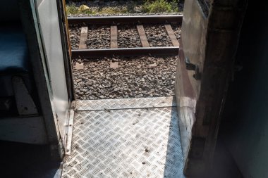 Mangalaore, India - January 20 2023: Metal footboard beside the door of a train run by Indian railways.