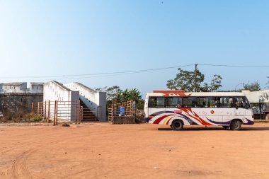 Mangalore, Hindistan - 18 Ocak 2023: Mangalore yakınlarındaki Boloor köyünde Tipu Sultan tarafından yapılan antik Bateri saat kulesinin önüne park edilmiş bir otobüs.