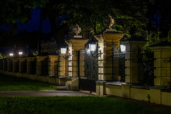 The main gate and the fence of the Mariinsky Palace on a summer night. The Mariinsky Palace is the official ceremonial residence of the President of Ukraine in Kyiv. Ukraine