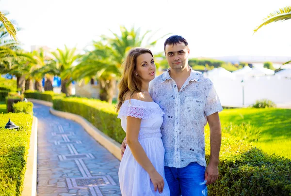 Enamored couple posing on a grass — Stock Photo, Image