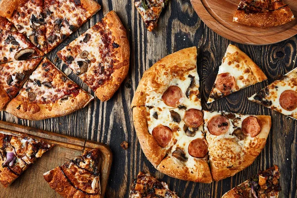 Pizza slices on wood background. Italian pizza on wooden table b