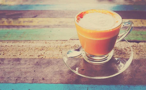 Glass cup of coffee and spoon — Stock Photo, Image