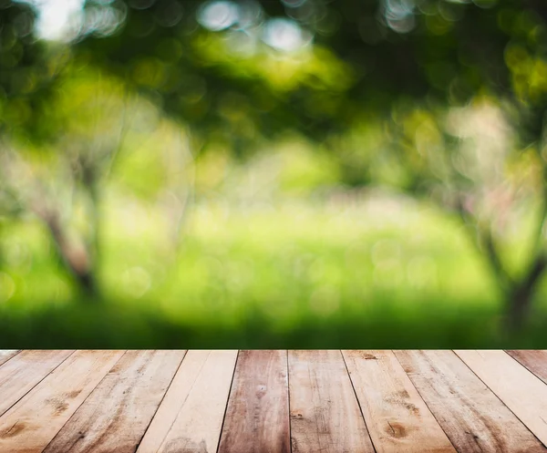 Wooden table top over abstract natural background — Stock Photo, Image