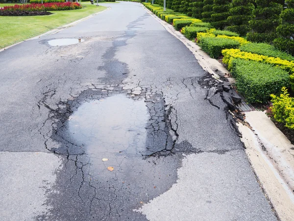 Potholes on damaged asphalt road — Stock Photo, Image