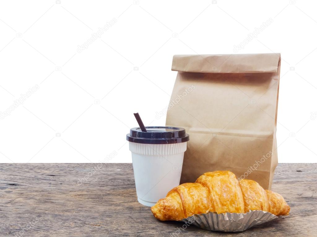 coffee and croissant with paper bag