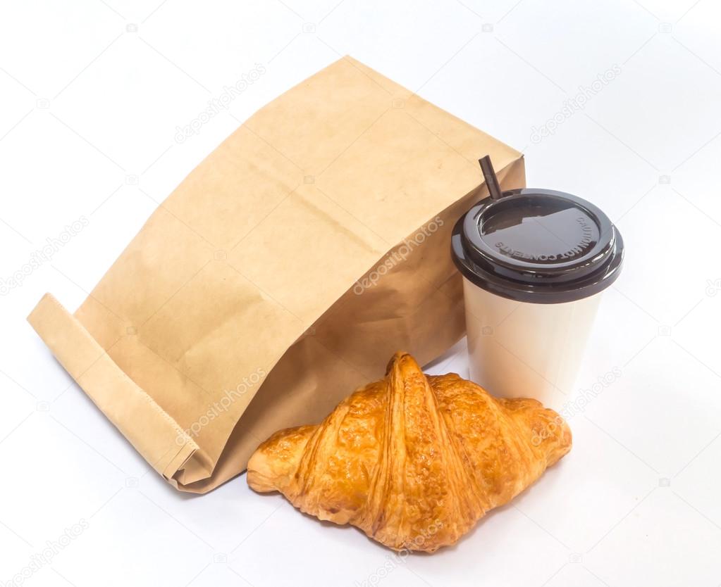 coffee and croissant with paper bag isolated