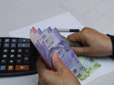 Şili banknotlarını sayan yaşlı bir kadının elleri